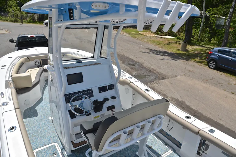 Slide: The Image of 2021 Tidewater 256 CC Adventure boat interior with helm and seating area. - 19