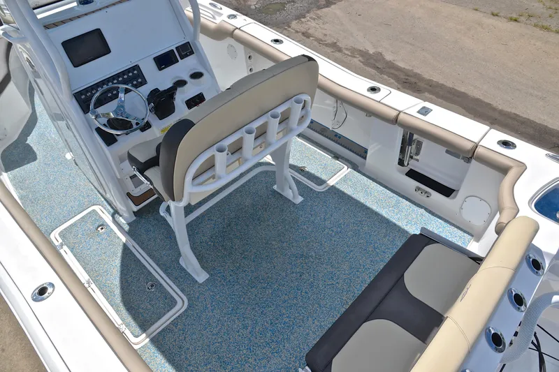 Slide: The Image of 2021 Tidewater 256 CC Adventure boat interior with helm, seating, and rod holders. - 20