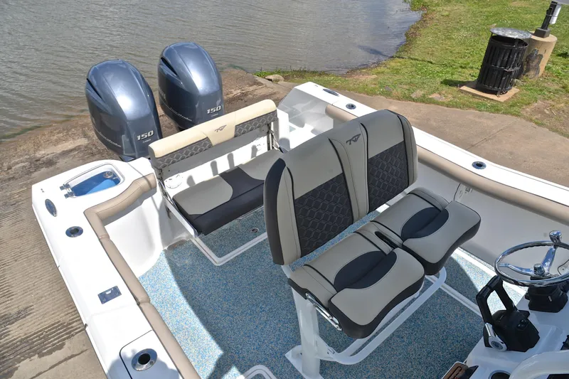 Slide: The Image of 2021 Tidewater 256 CC Adventure boat interior with dual engines and seating. - 21