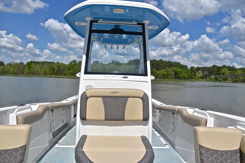 Slide: The Image of 2021 Tidewater 256 CC Adventure boat interior on a scenic lake with blue sky. - 23