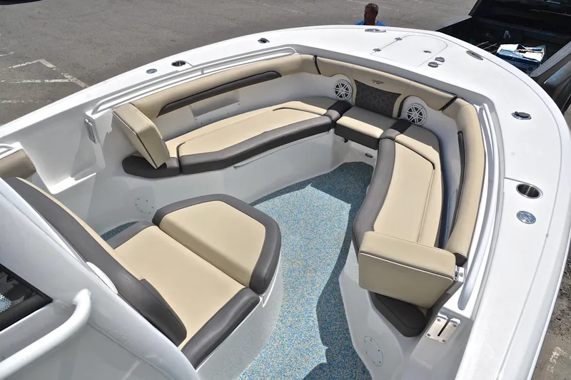 Slide: The Image of 2021 Tidewater 256 CC Adventure boat interior with beige seating and speakers. - 24