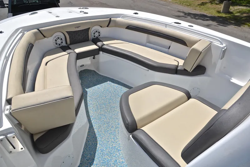 Slide: The Image of 2021 Tidewater 256 CC Adventure boat interior with cushioned seating and speakers. - 25