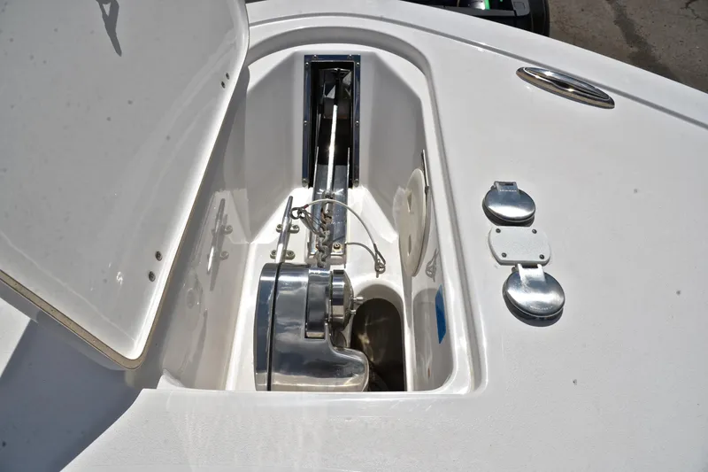 Slide: The Image of Anchor compartment of 2021 Tidewater 256 CC Adventure boat, showcasing storage and hardware. - 29