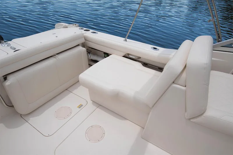 Slide: The Image of Manufacturer Provided Image: 2017 Grady-White Freedom 235 boat interior with white seating and water backdrop. - 17