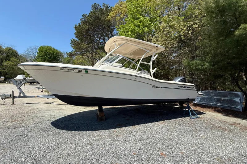 The Image of 2017 Grady-White Freedom 235 boat on gravel, surrounded by trees. - 19
