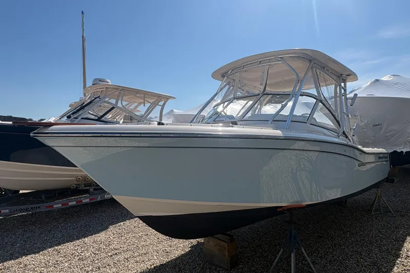Slide: The Image of 2017 Grady-White Freedom 235 boat on display under clear blue sky. - 2