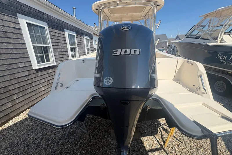 Slide: The Image of 2017 Grady-White Freedom 235 boat with 300 horsepower engine, docked outdoors. - 3