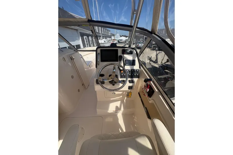 Slide: The Image of 2017 Grady-White Freedom 235 boat cockpit with steering wheel and control panel. - 5