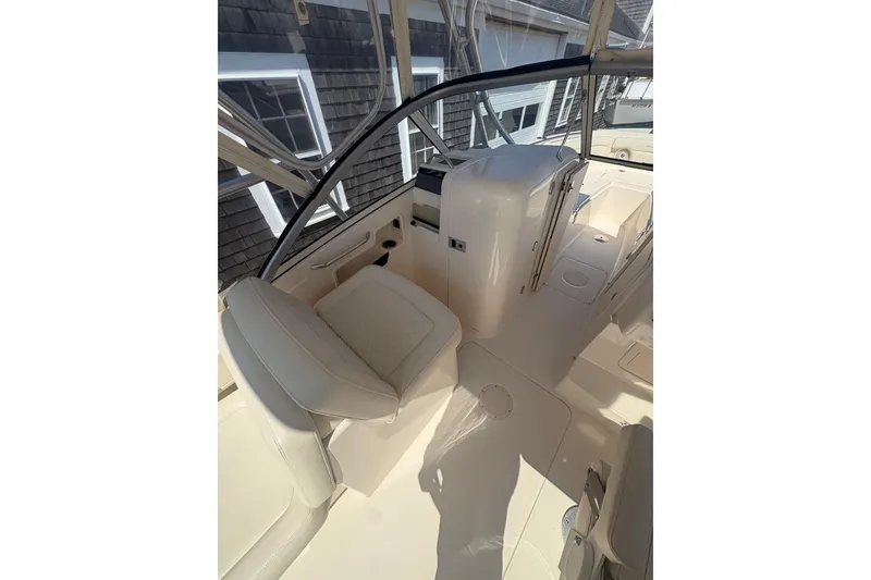 Slide: The Image of 2017 Grady-White Freedom 235 boat interior with seating and helm station. - 8