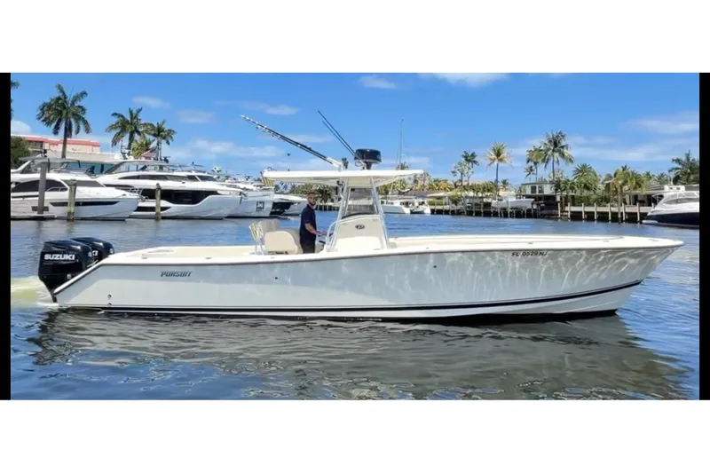 The Image of 2006 Pursuit 3480 Center Console boat on water with palm trees in background. - 0