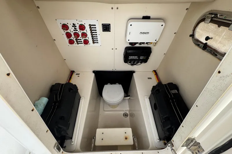 Slide: The Image of 2006 Pursuit 3480 Center Console interior with control panel and marine toilet. - 13
