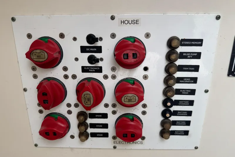 Slide: The Image of Control panel of a 2006 Pursuit 3480 Center Console boat with switches and labels. - 14