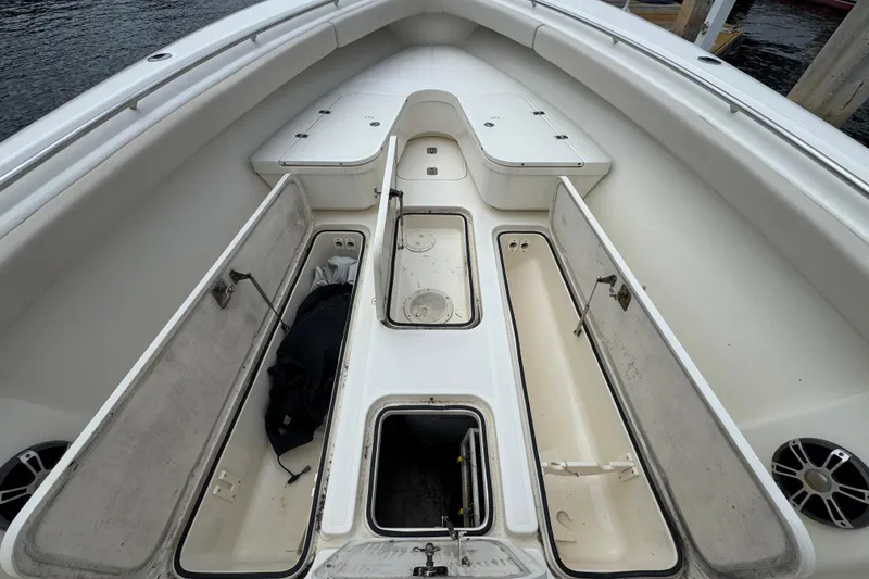 Slide: The Image of Engine compartment of a 2006 Pursuit 3480 Center Console boat with visible hoses and components. - 20