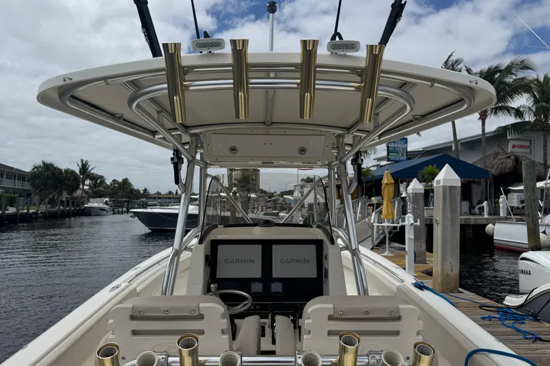 Slide: The Image of 2006 Pursuit 3480 Center Console boat dashboard with Garmin navigation displays and steering wheel. - 6