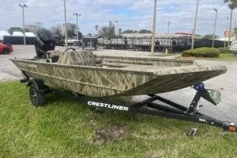 Slide: The Image of 2026 Crestliner 1760 Retriever SC boat on trailer, parked outdoors. - 4