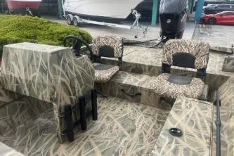 Slide: The Image of 2026 Crestliner 1760 Retriever SC boat with camouflage seating and steering console. - 8