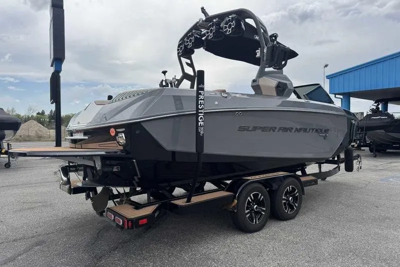 Slide: The Image of 2019 Nautique Super Air Nautique G23 boat on trailer, gray exterior, parked outdoors. - 10