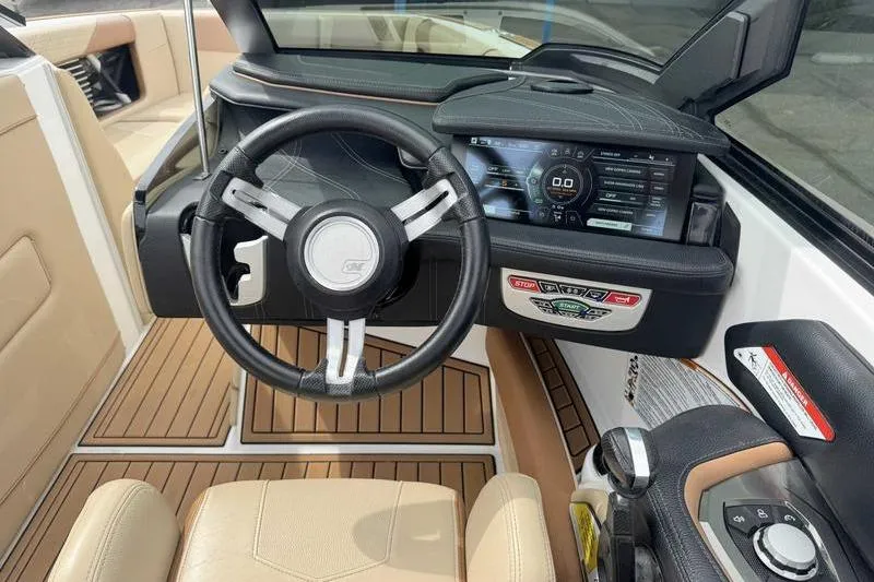 Slide: The Image of 2019 Nautique Super Air Nautique G23 dashboard with steering wheel and digital display. - 12
