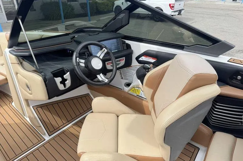 Slide: The Image of 2019 Nautique Super Air Nautique G23 boat interior with steering wheel and dashboard. - 13