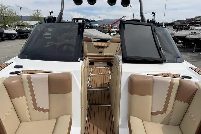 Slide: The Image of 2019 Nautique Super Air Nautique G23 interior with tan seating and teak flooring. - 14