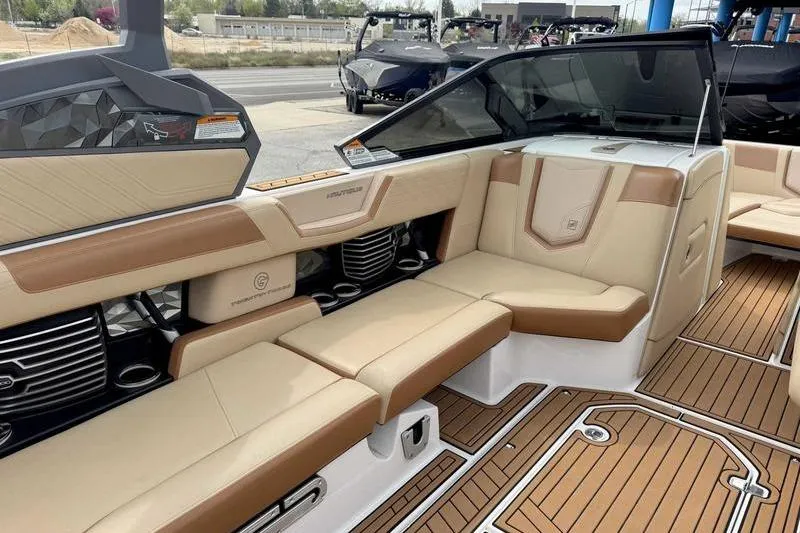Slide: The Image of 2019 Nautique Super Air Nautique G23 interior with tan leather seating and teak flooring. - 8