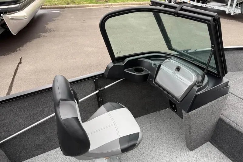 Slide: The Image of 2026 Crestliner 1650 Kodiak boat interior with seat and windshield. - 11