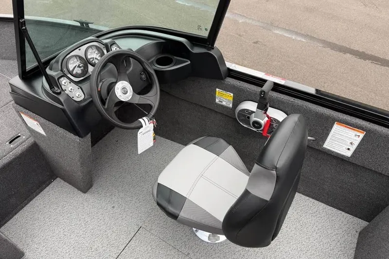 Slide: The Image of 2026 Crestliner 1650 Kodiak boat interior with steering wheel and captain's chair. - 12