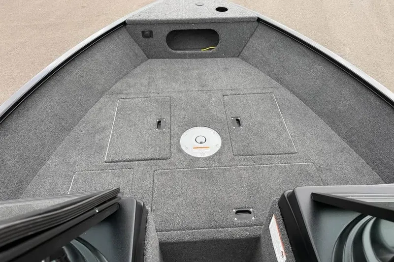 Slide: The Image of 2026 Crestliner 1650 Kodiak boat interior with carpeted deck and storage compartments. - 14