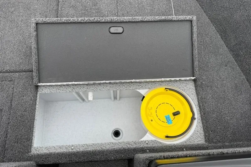 Slide: The Image of Crestliner 1650 Kodiak 2026 boat storage compartment with yellow lid and gray interior. - 16