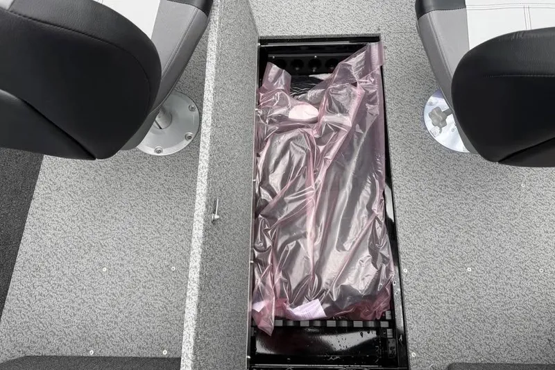 Slide: The Image of 2026 Crestliner 1650 Kodiak boat interior with storage compartment between seats. - 17