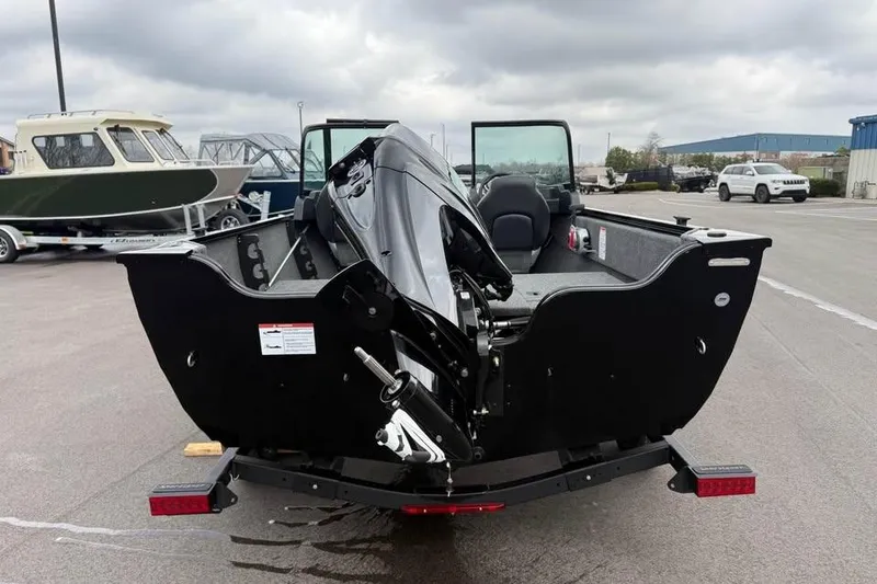 Slide: The Image of 2026 Crestliner 1650 Kodiak boat with outboard motor, parked on a trailer in a lot. - 6