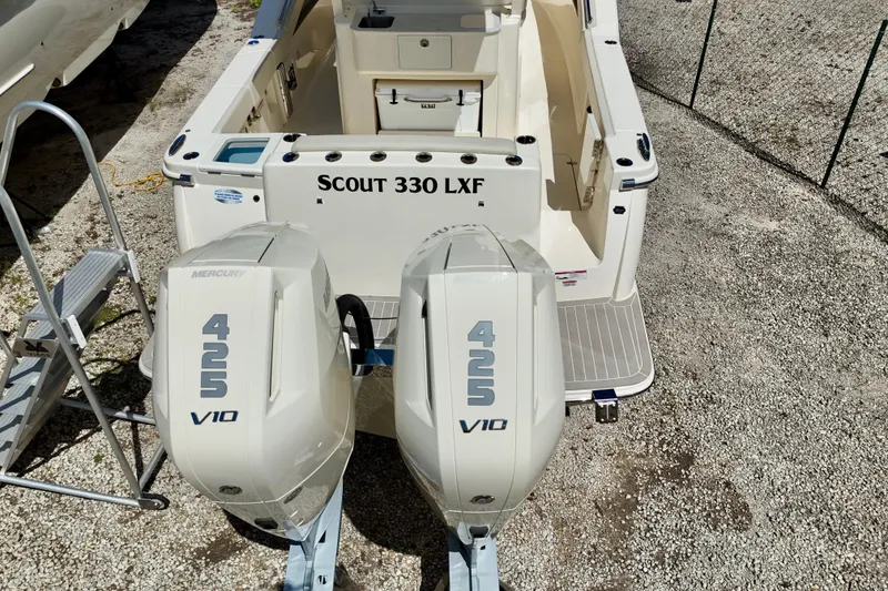 Slide: The Image of 2026 Scout 330 LXF boat with dual Mercury 425 V10 engines, rear view. - 20