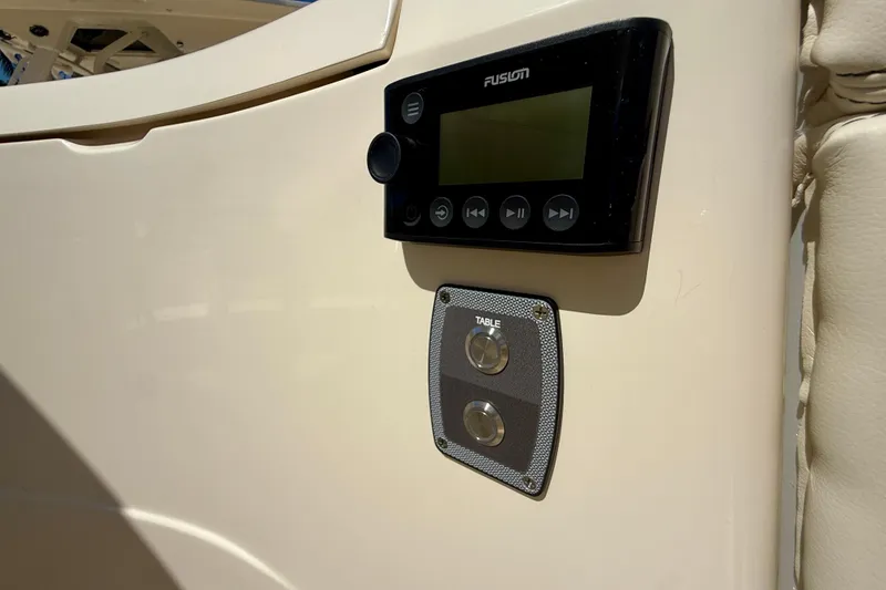 Slide: The Image of Control panel on 2026 Scout 330 LXF boat, featuring Fusion audio system and table controls. - 24