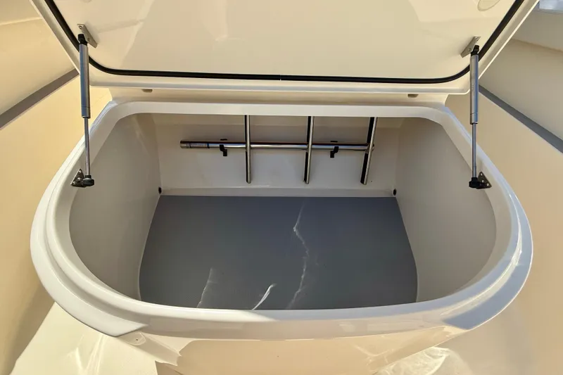 Slide: The Image of Open storage compartment on 2026 Scout 330 LXF boat, showcasing spacious interior. - 30