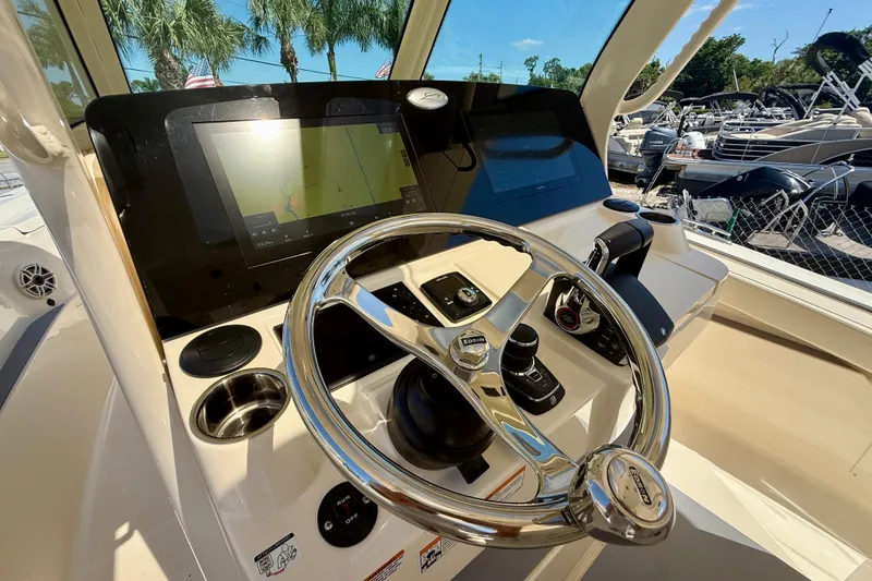 Slide: The Image of Helm of 2026 Scout 330 LXF boat with modern navigation system and controls. - 35