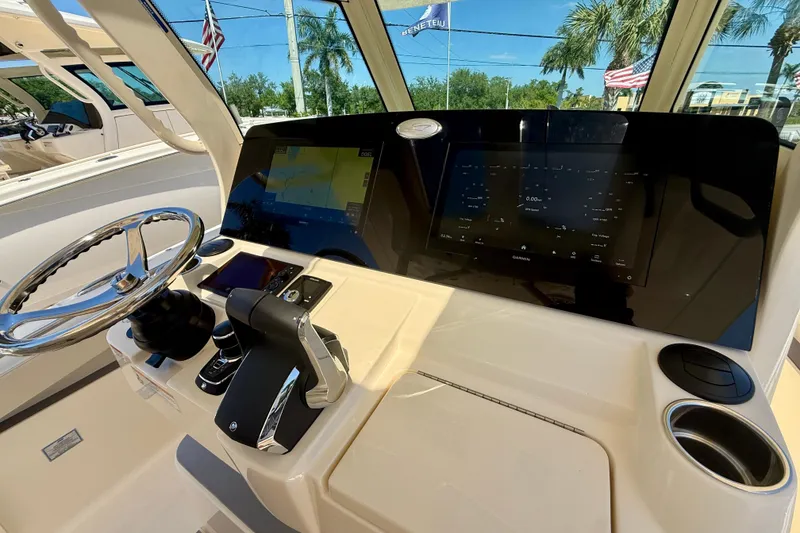 Slide: The Image of Helm of 2026 Scout 330 LXF boat with advanced navigation display and controls. - 36