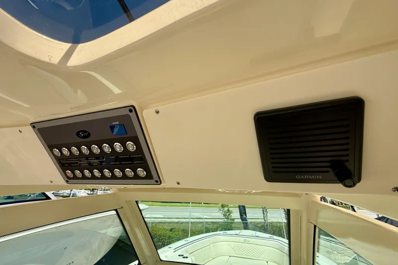 Slide: The Image of 2026 Scout 330 LXF boat dashboard with control panel and Garmin device. - 37