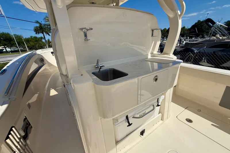 Slide: The Image of 2026 Scout 330 LXF boat interior with sink and storage area. - 39