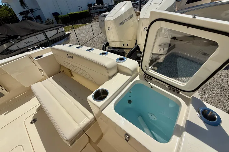 Slide: The Image of 2026 Scout 330 LXF boat interior with seating and open storage compartment. - 41