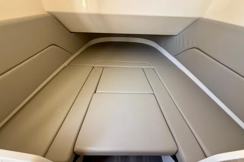 Slide: The Image of 2026 Scout 330 LXF cabin interior with beige cushioned seating. - 44