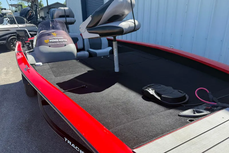 Slide: The Image of 2007 Tracker Pro Team 175 TXW boat with Minn Kota trolling motor, red and black design. - 18