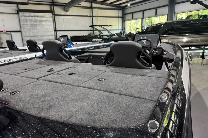 Slide: The Image of 2026 Skeeter ZXR21 SE boat interior with dual seats and spacious deck in showroom. - 11