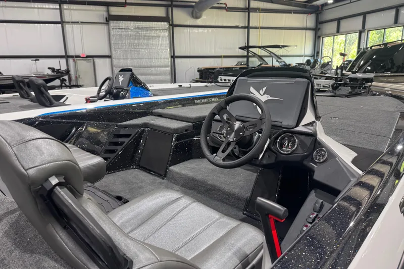 Slide: The Image of 2026 Skeeter ZXR21 SE boat interior with steering wheel and dashboard in showroom. - 12