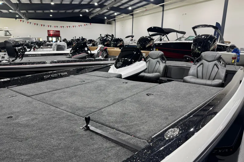 Slide: The Image of 2026 Skeeter ZXR21 SE boat with spacious seating and sleek design in showroom. - 7