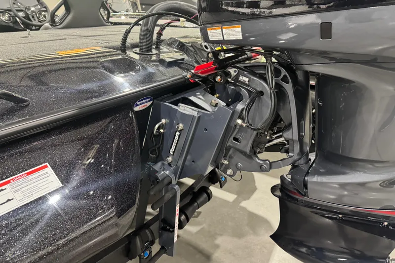 Slide: The Image of 2026 Skeeter ZXR21 SE boat engine and transom detail in showroom setting. - 9