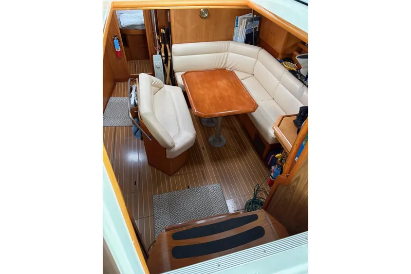 Slide: The Image of Interior of 2001 Jeanneau Sun Odyssey 45.2 sailboat with cozy seating and wooden table. - 1