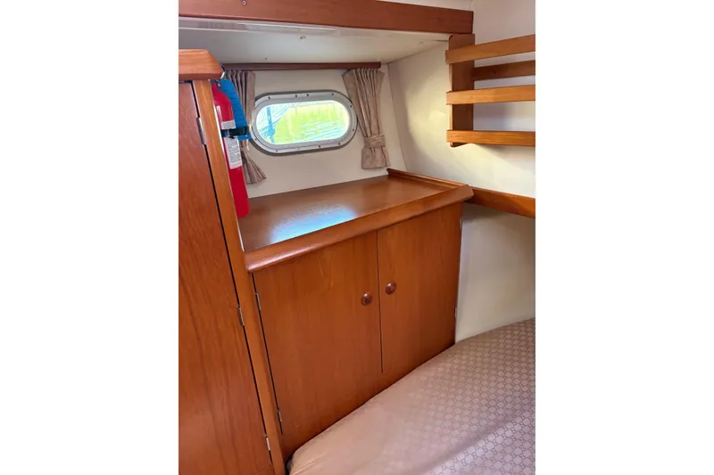Slide: The Image of Interior cabin of 2001 Jeanneau Sun Odyssey 45.2 sailboat with wooden cabinetry and window. - 10