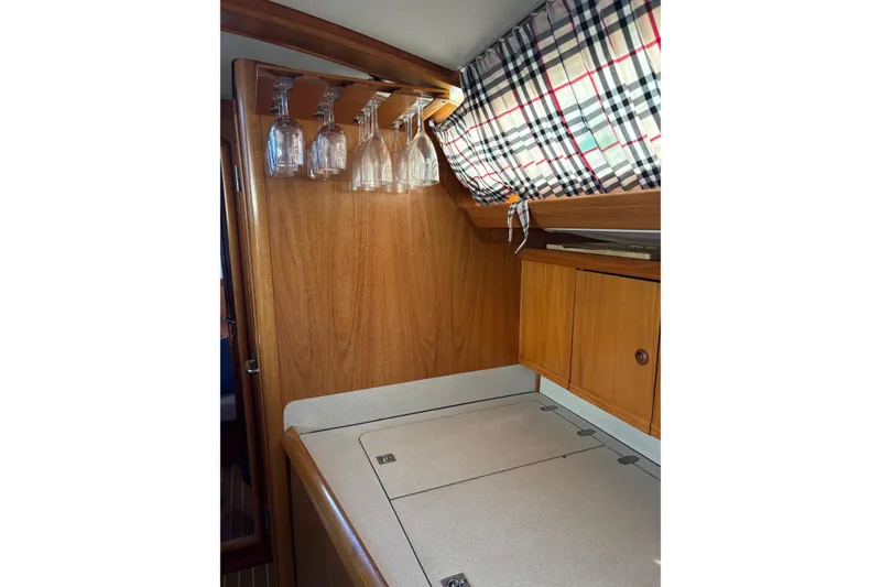 Slide: The Image of Interior of 2001 Jeanneau Sun Odyssey 45.2 yacht with wooden cabinetry and hanging glassware. - 12
