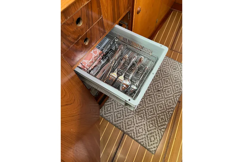 Slide: The Image of Cutlery drawer in Jeanneau Sun Odyssey 45.2 yacht, 2001 model, with wooden cabinetry. - 15
