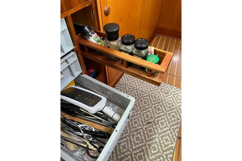 Slide: The Image of Kitchen drawer with spices and utensils on Jeanneau Sun Odyssey 45.2 yacht, 2001 model. - 18